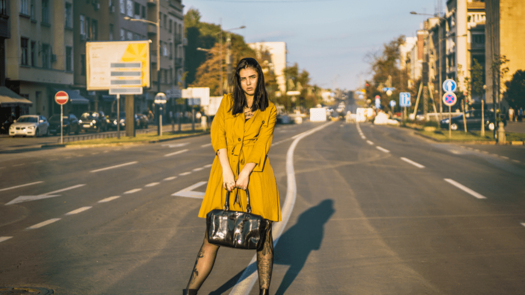 A beautiful person standing in the middle of a city street