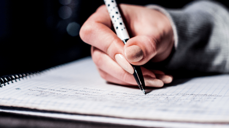 woman writing in her notes