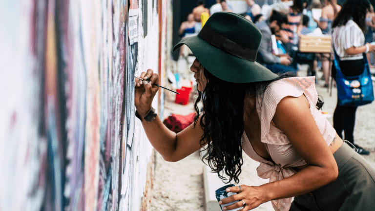 woman painting on wall