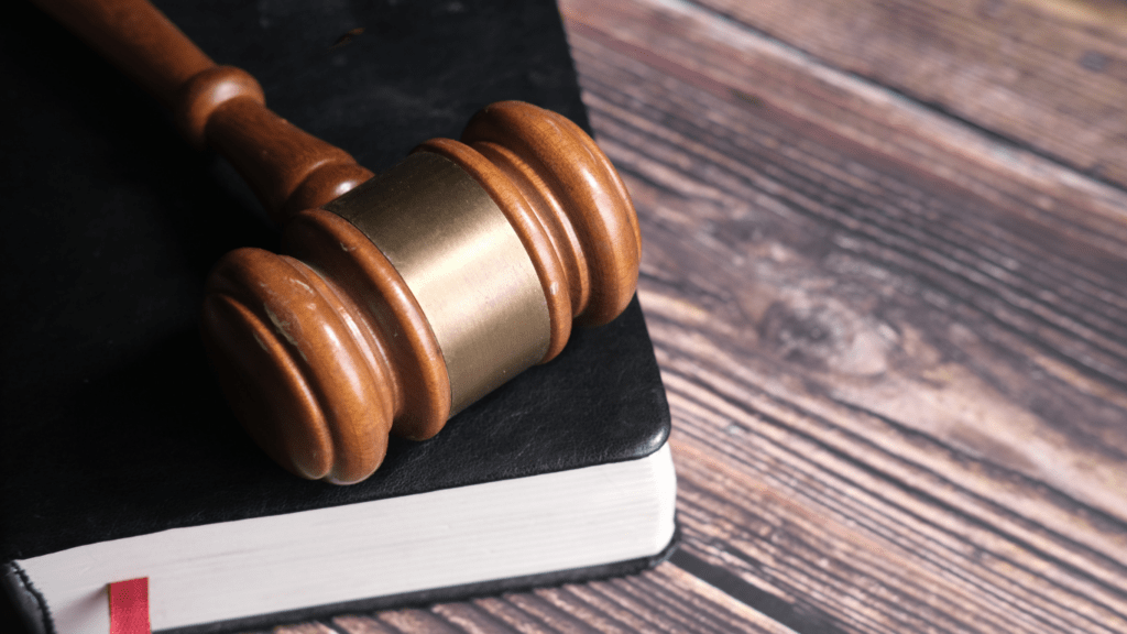 judge's gavel and book on wooden table