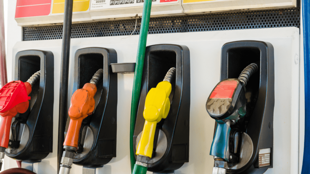 Several gas pumps are filled with different colors