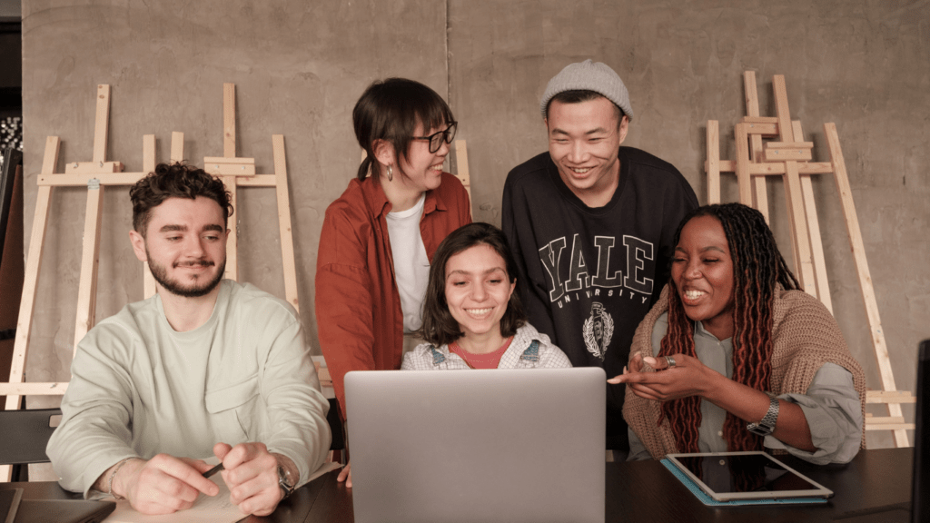 a group of people working on a laptop