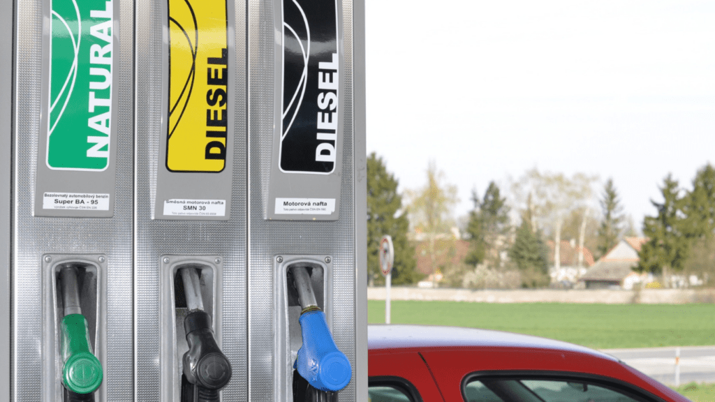 Several gas pumps are filled with different colors