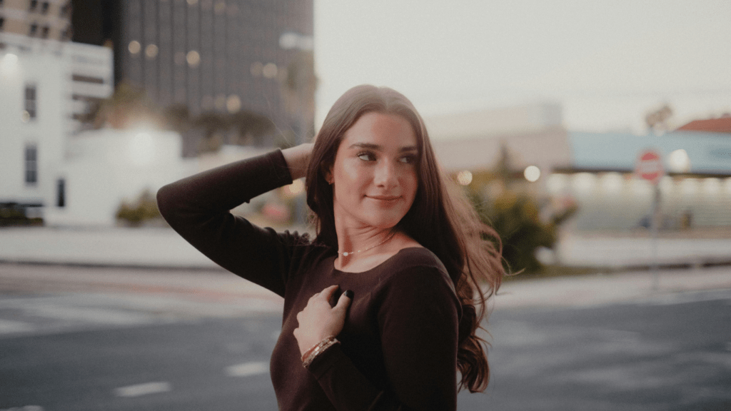 A beautiful person standing in the middle of a city street