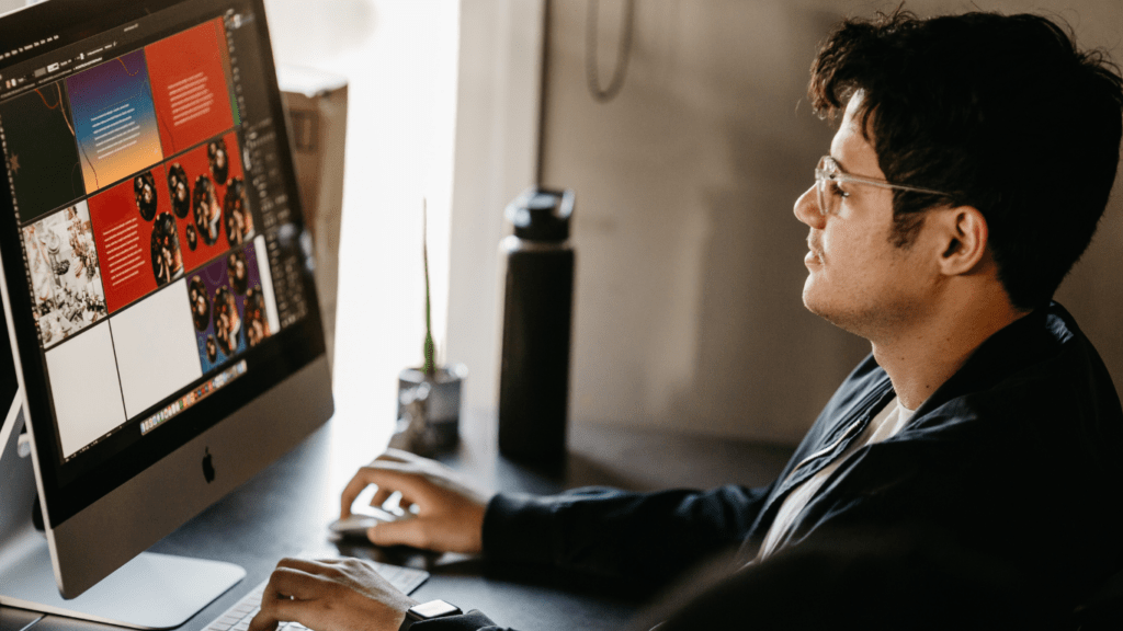 a person sitting at a desk in front of a computer screen