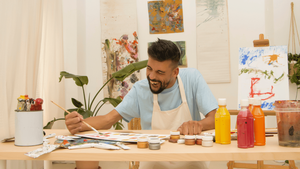 a person sitting at a table in front of a painting