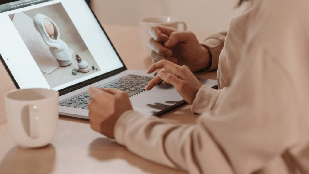 a person is sitting at a table with a laptop