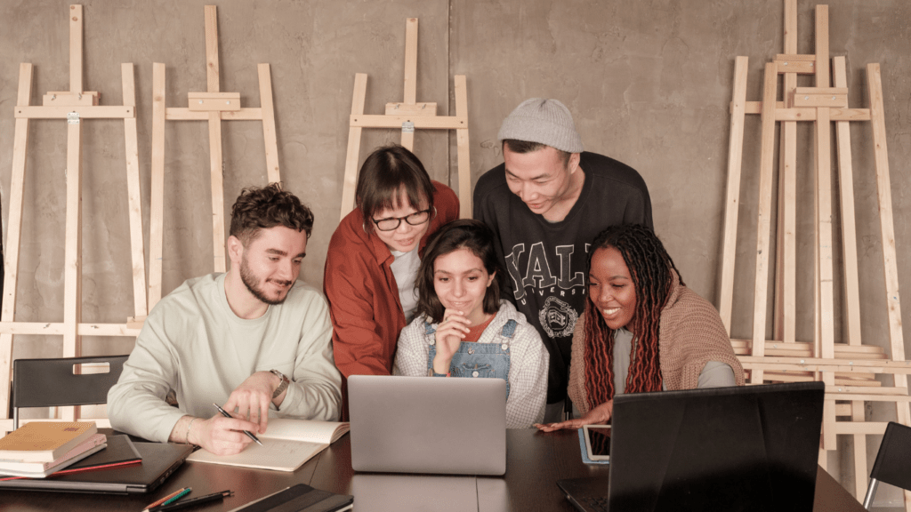 a group of people working on a laptop