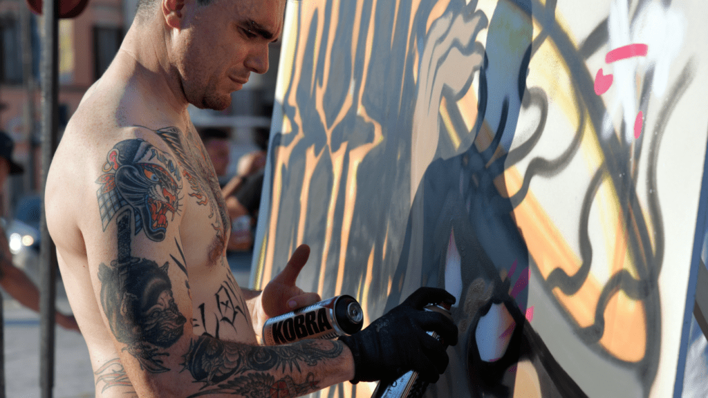 a person is painting a colorful painting on a wall