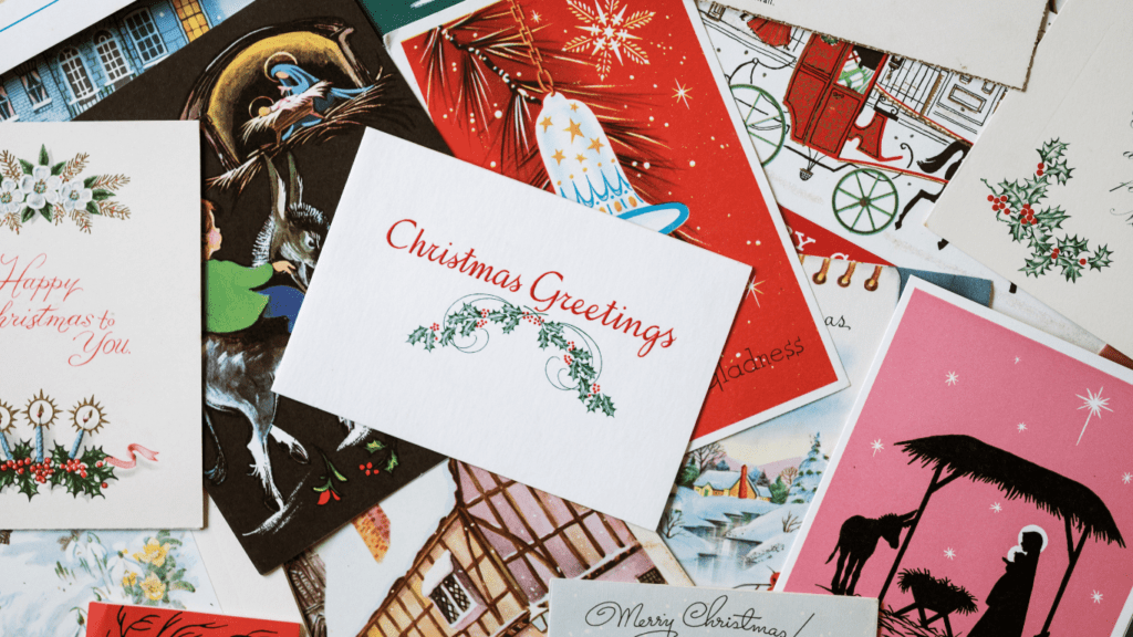 christmas cards are laid out on a table with paintbrushes and watercolors